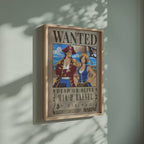 Video of the custom One Piece Wanted poster for Mia and Rafael in a light wood frame on a sage green wall