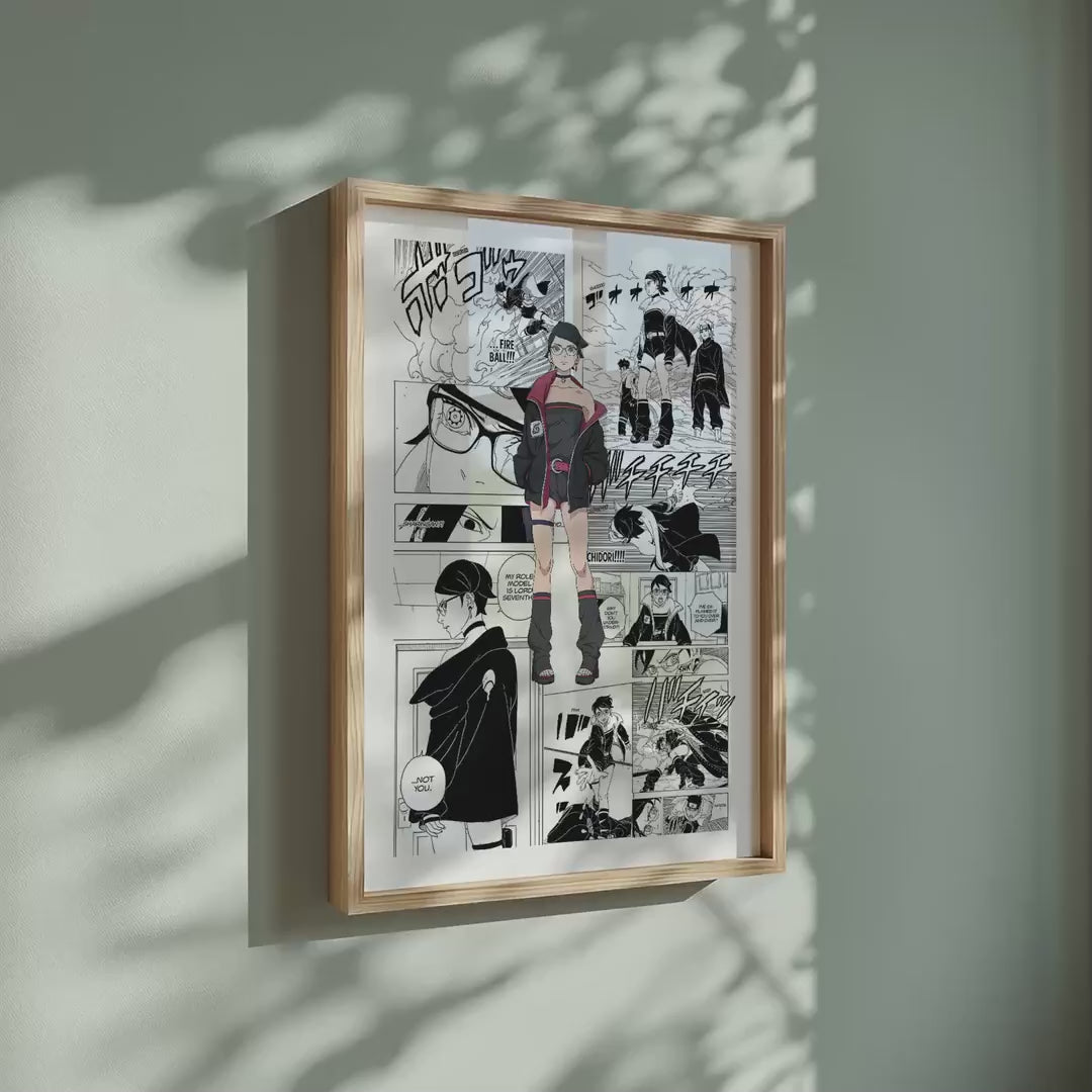 Video of the Sarada Uchiha manga poster inspired by Naruto in a light wood frame on a sage green wall